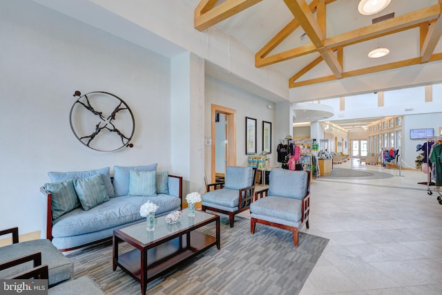 tiled living room with beam ceiling and high vaulted ceiling