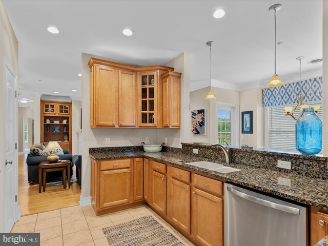 kitchen with sink, hanging light fixtures, crown molding, dark stone countertops, and stainless steel dishwasher