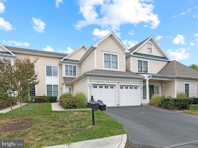 view of front of property with a garage and a front lawn