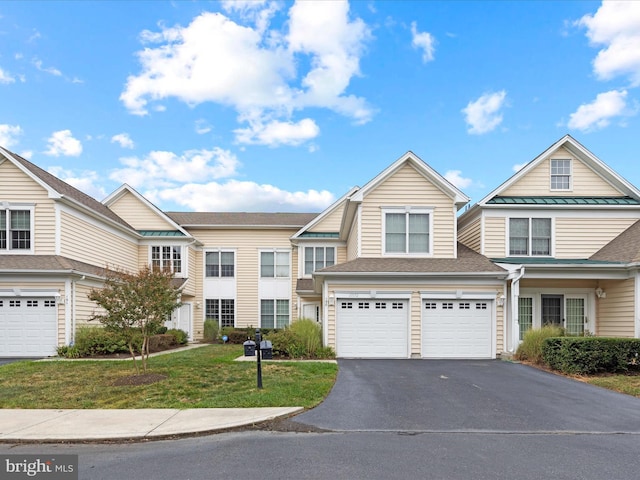 view of front of property featuring a garage and a front lawn