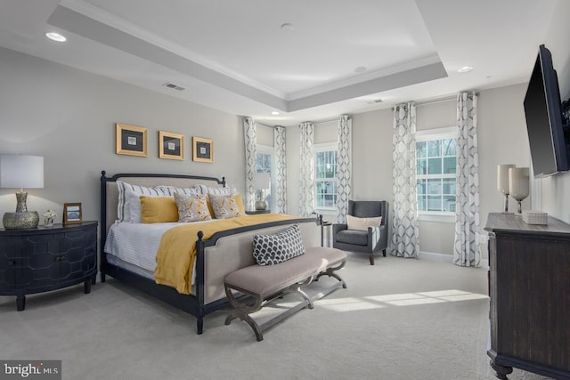 carpeted bedroom featuring crown molding and a tray ceiling