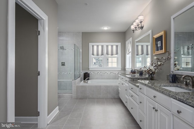 bathroom featuring plus walk in shower, tile patterned flooring, and vanity