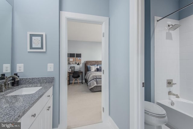 full bathroom with tiled shower / bath, vanity, and toilet