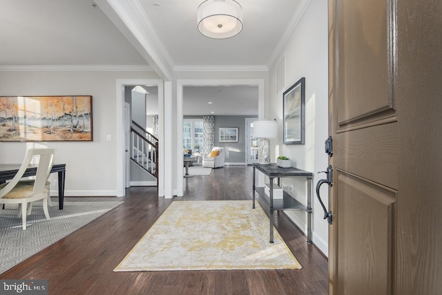 foyer entrance featuring dark hardwood / wood-style floors and crown molding