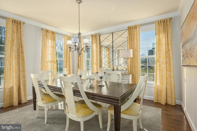 dining room with an inviting chandelier, dark wood-type flooring, a healthy amount of sunlight, and crown molding