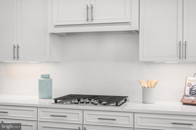 kitchen featuring white cabinets, tasteful backsplash, and stainless steel gas cooktop