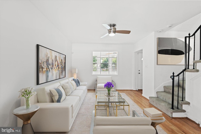 living room featuring light wood-type flooring and ceiling fan