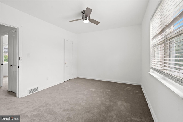 unfurnished room with ceiling fan and carpet floors