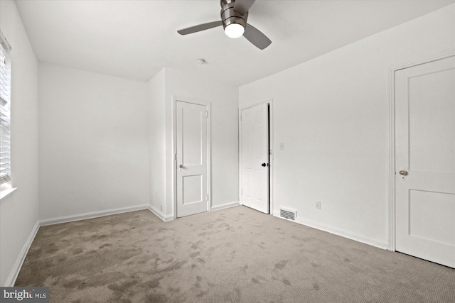 unfurnished bedroom with ceiling fan and light carpet