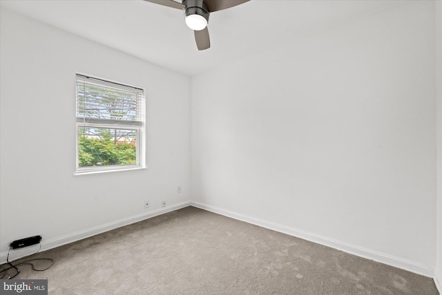 spare room featuring ceiling fan and carpet