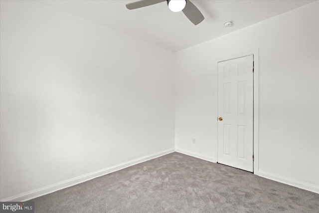 carpeted spare room featuring ceiling fan