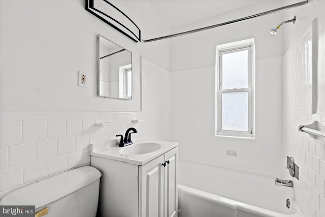 413 36th St NE, Washington, DC 20019 - bathroom featuring toilet, vanity, shower / bathtub combination, wainscoting, and tile walls