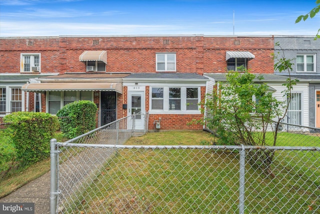 413 36th St NE, Washington, DC 20019 - townhome / multi-family property with a front yard, a fenced front yard, and brick siding