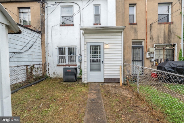 rear view of house with central AC unit