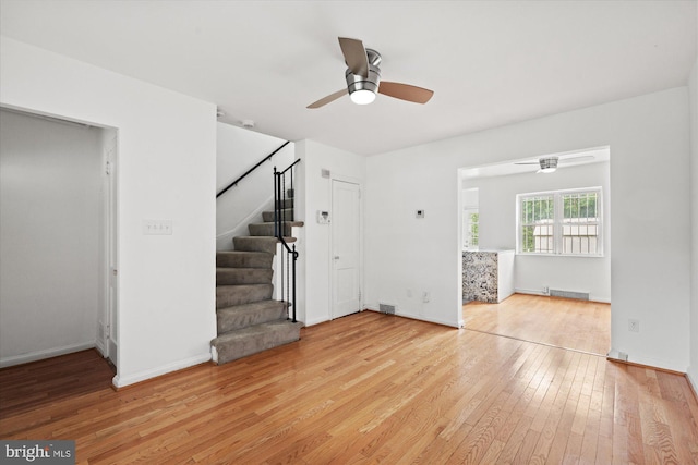 413 36th St NE, Washington, DC 20019 - unfurnished living room with stairway, baseboards, hardwood / wood-style flooring, visible vents, and a ceiling fan