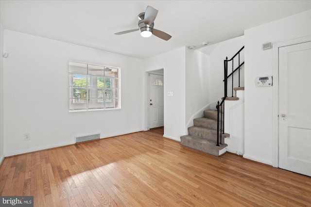 413 36th St NE, Washington, DC 20019 - unfurnished living room featuring stairs, baseboards, ceiling fan, light wood-style flooring, and visible vents