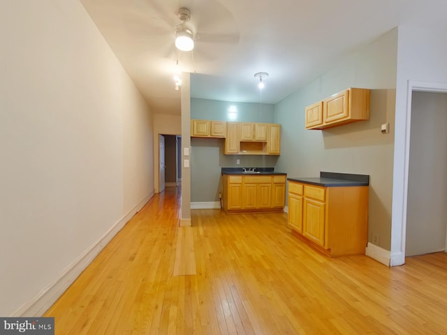 kitchen with light brown cabinetry, light hardwood / wood-style flooring, sink, and ceiling fan