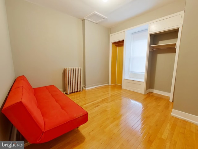 unfurnished room with radiator and hardwood / wood-style flooring