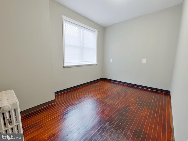 unfurnished room with wood-type flooring