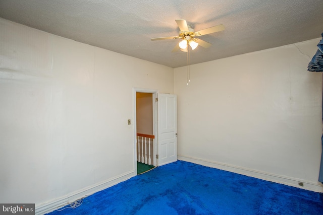 unfurnished bedroom with ceiling fan, carpet floors, and a textured ceiling