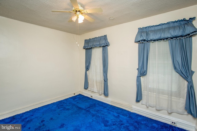 unfurnished bedroom with carpet, ceiling fan, and a textured ceiling