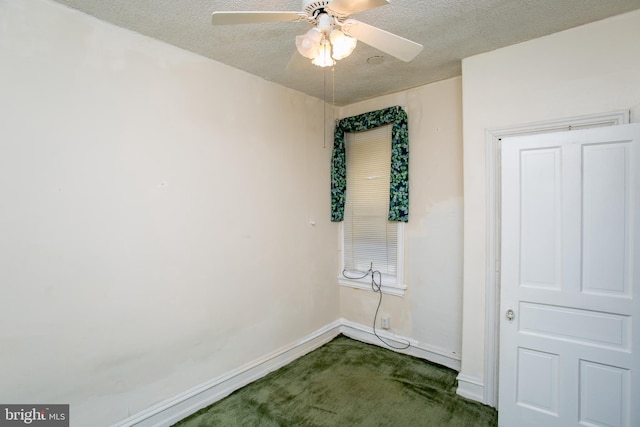 carpeted spare room with a textured ceiling and ceiling fan