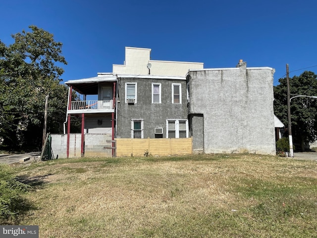 exterior space featuring a balcony and a lawn