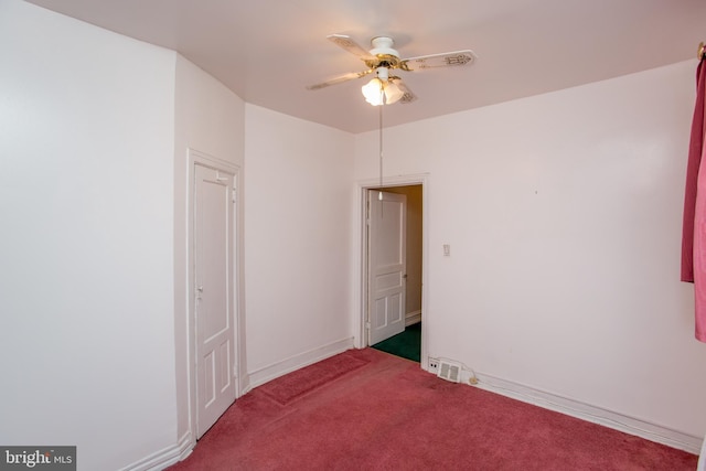 carpeted empty room with ceiling fan