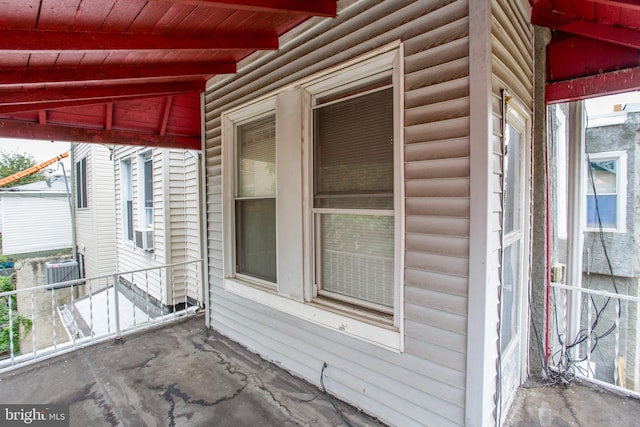 view of side of home with central AC