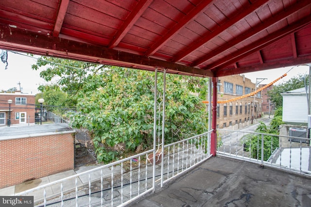 view of patio with a balcony and central AC unit