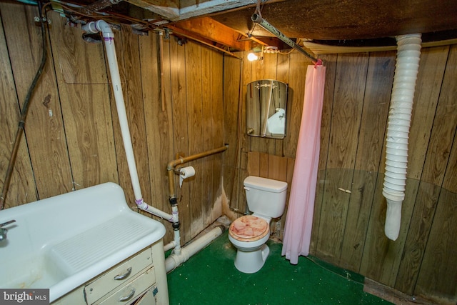 bathroom featuring wood walls and toilet