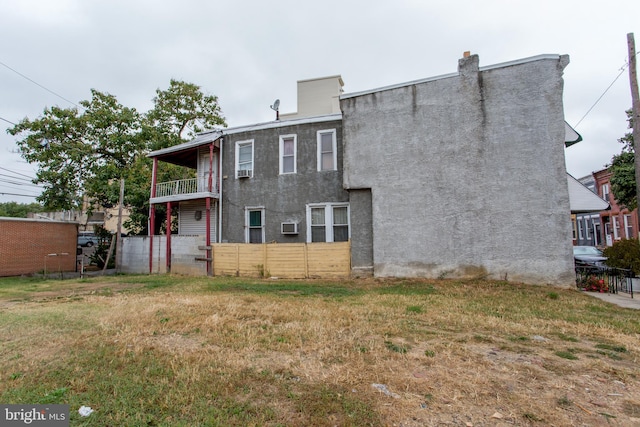 back of property featuring a balcony