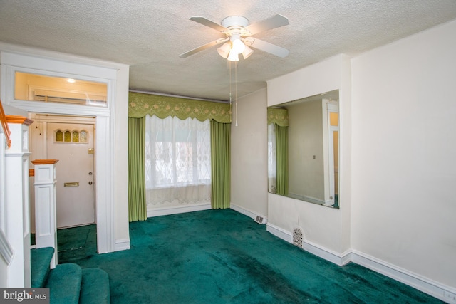 unfurnished bedroom featuring dark colored carpet, ceiling fan, and a textured ceiling