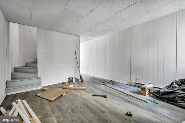 interior space with wood walls and dark hardwood / wood-style floors