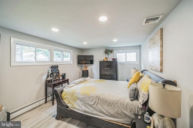 bedroom featuring light hardwood / wood-style floors and baseboard heating