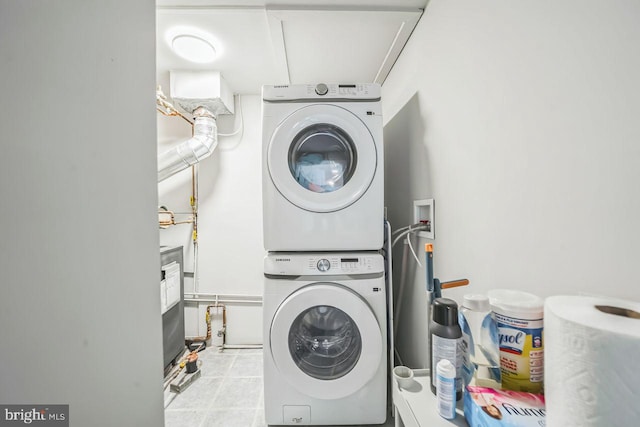 laundry area featuring stacked washer and clothes dryer