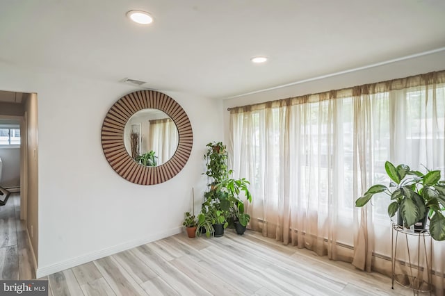 unfurnished room with light hardwood / wood-style floors