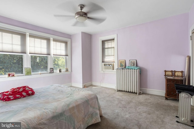 bedroom with light carpet, radiator heating unit, cooling unit, and ceiling fan