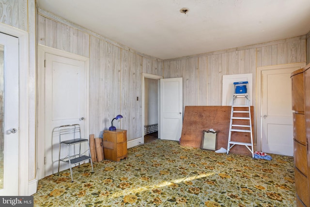 bedroom featuring wood walls