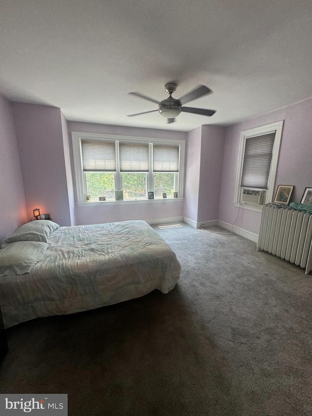 bedroom featuring cooling unit, ceiling fan, carpet floors, and a textured ceiling