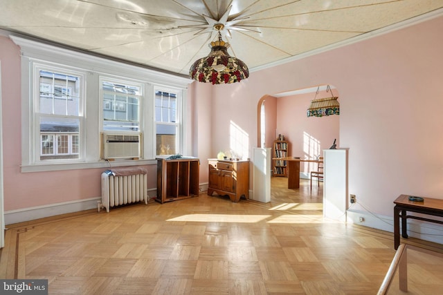 interior space with ornamental molding, cooling unit, light parquet floors, and radiator heating unit