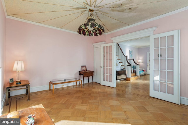 sitting room with french doors, crown molding, and light parquet flooring