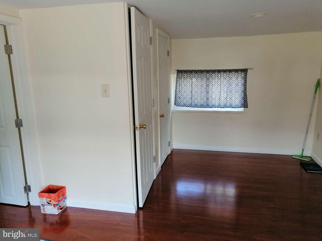 hallway featuring dark hardwood / wood-style flooring