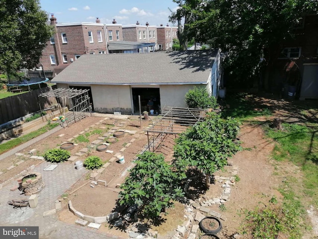 rear view of property with a trampoline