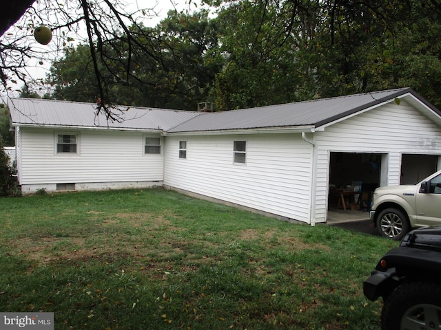 view of side of home with a yard