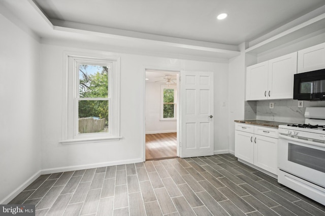 kitchen featuring white cabinets, ceiling fan, white range with gas cooktop, and dark hardwood / wood-style flooring