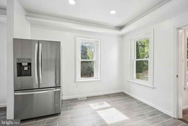 kitchen with hardwood / wood-style flooring, stainless steel fridge with ice dispenser, and a wealth of natural light