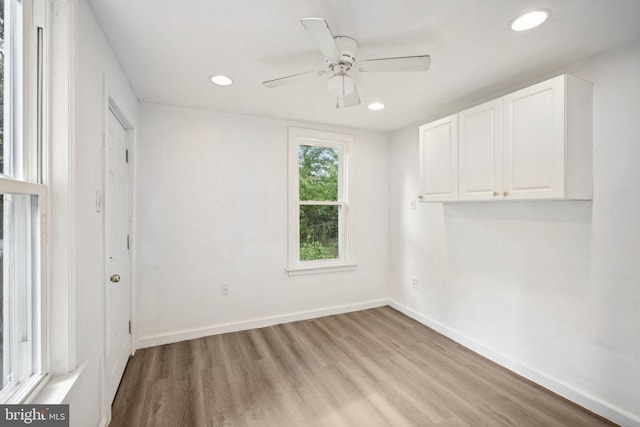 empty room featuring light wood-type flooring and ceiling fan