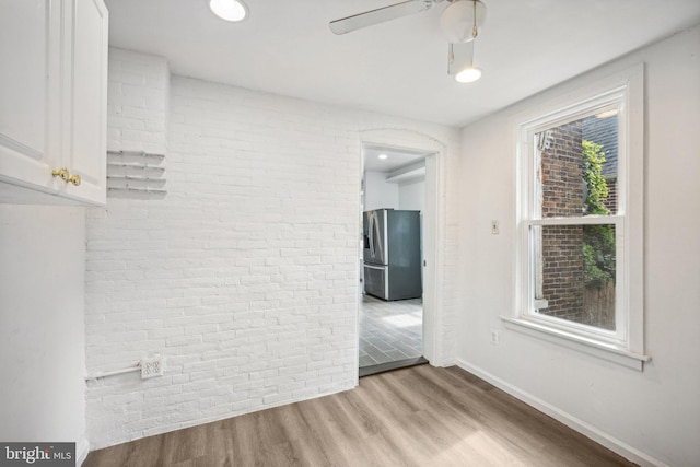 spare room with ceiling fan and light hardwood / wood-style flooring