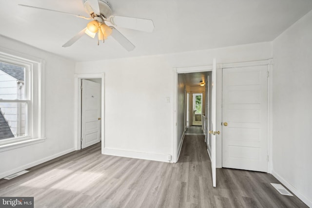 unfurnished bedroom featuring wood-type flooring and ceiling fan